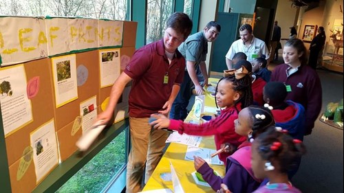 STEM, Leaves, and Trees Event - Students lined up at exhibitor table