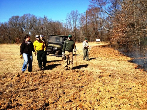 Group of people prepare for a prescribed burning demonstration at a Fire on the Forty workshop