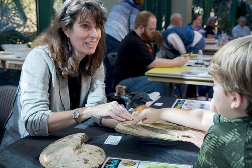 Expert does a fossil demonstration for children at the Fossil Road Show