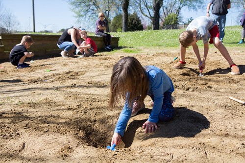 Children dig for fossil at the Fossil Road Show