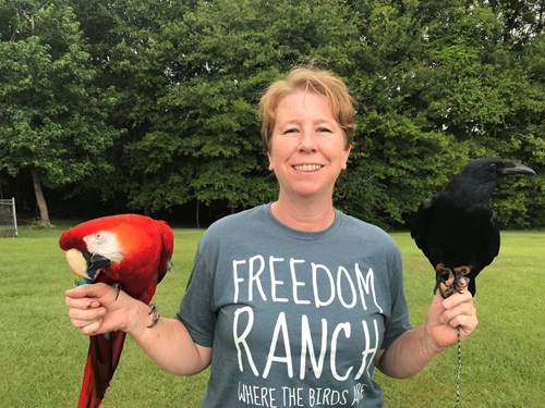 Woman from Freedom Ranch holds two birds