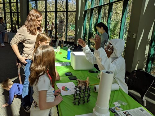 Students watch a chemistry experiment at the Science Makers event