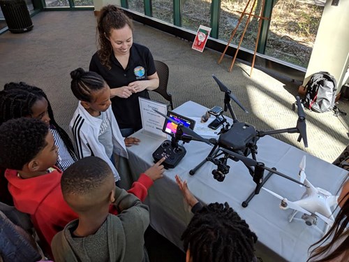 Students examine a drone at the Science Makers event