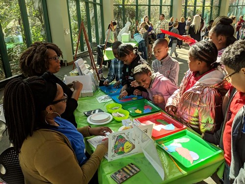 Students gather around an exhibit at the Science Makers event